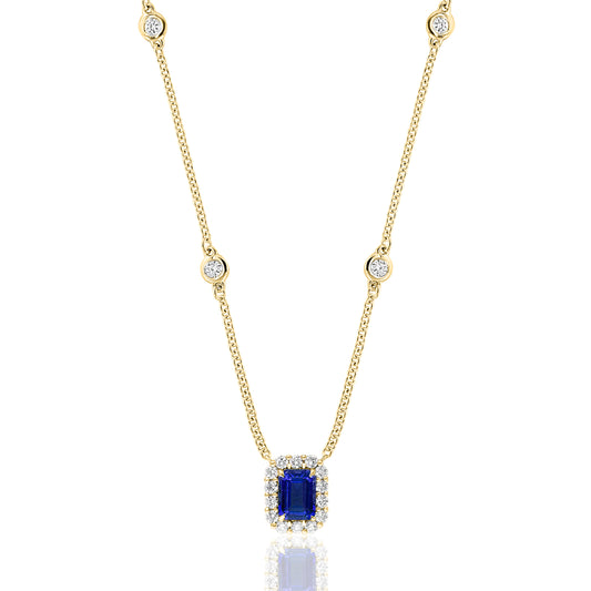 18K yellow gold emerald-cut sapphire with a diamond halo on a diamond bezel chain.